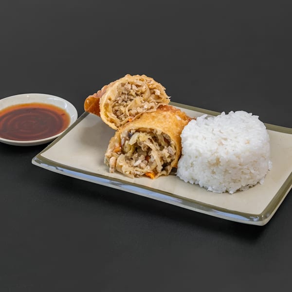 Blasian Fusion egg rolls, one cut open to show filling, with a side of white rice and dipping sauce.
